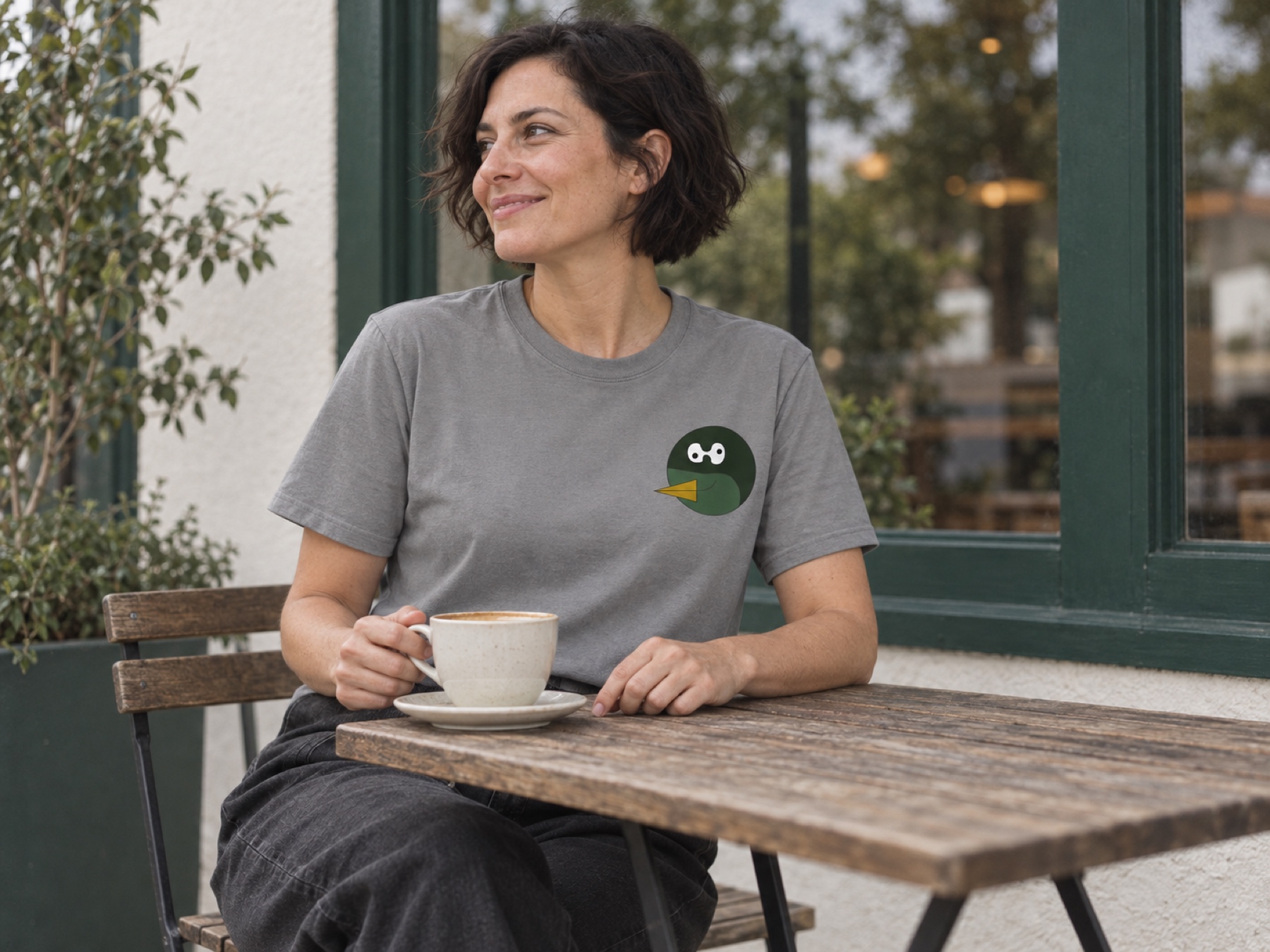 Generated campaign concept: an adult in a grey Duckiepoos tee taking a coffee break